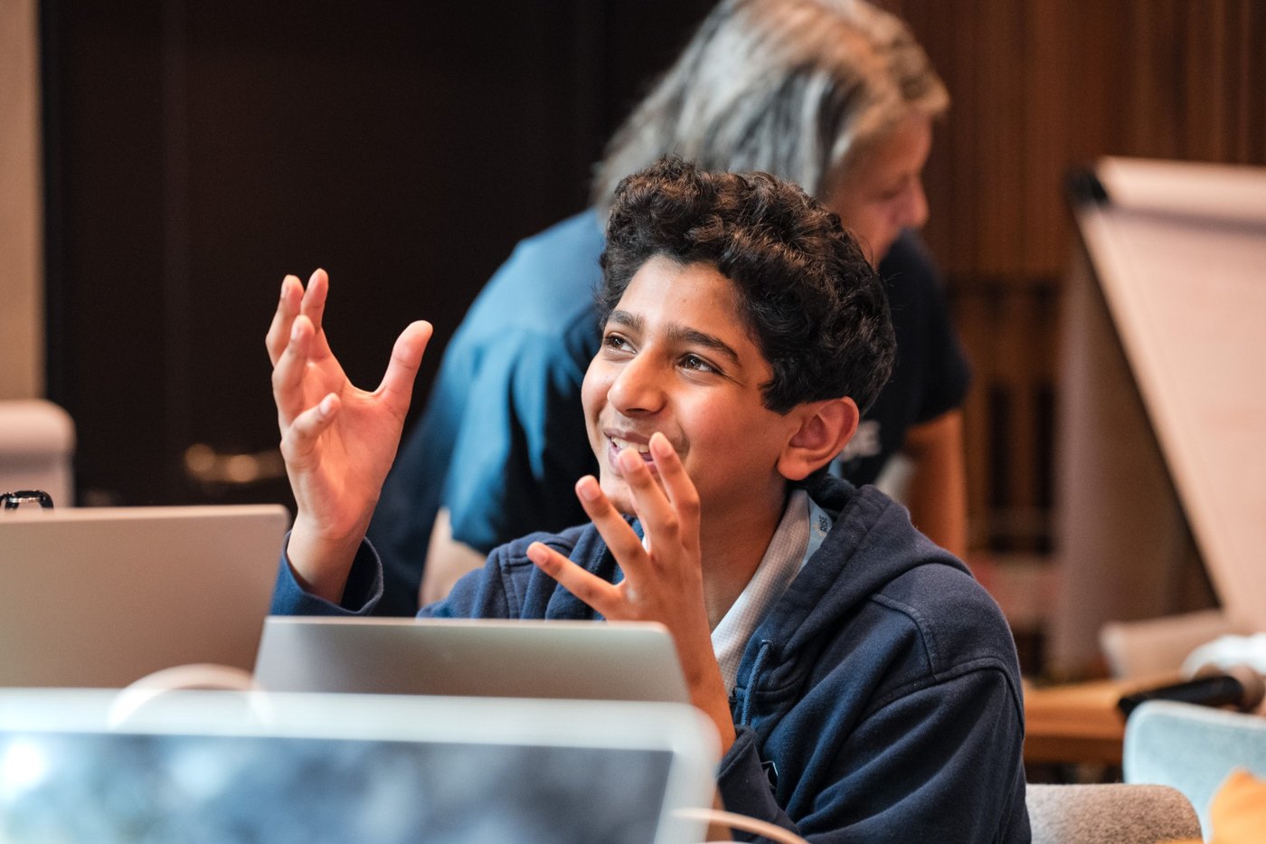 Smaran smiling and gesturing during a discussion at the Rise Global Summit
